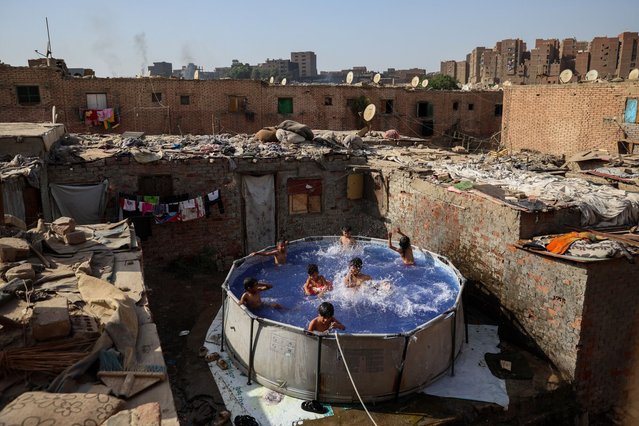 Youths cool off in a swimming pool during high temperatures in the Al Dewika district of Cairo, Egypt, on Saturday, June 8, 2024.  While the planet has now seen 12 consecutive months of record-breaking heat, global warming is a particularly severe problem for Egypt, a desert country heating up at one of the world's fastest rates. (Photo by Islam Safwat/Bloomberg)