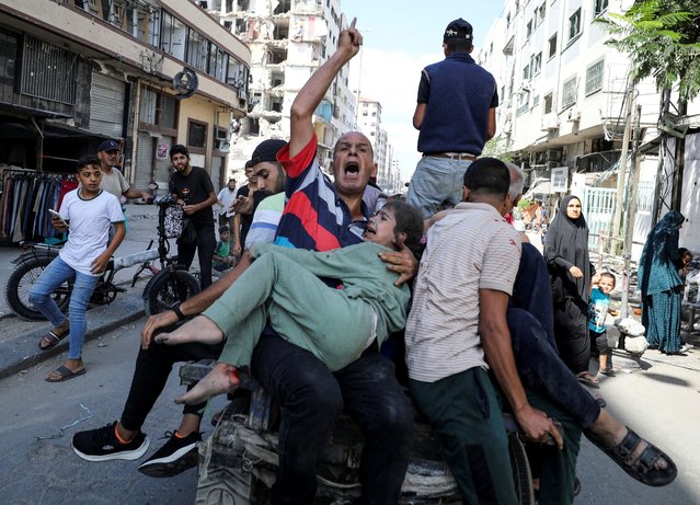 Palestinians react in the aftermath of an Israeli strike at al-Remal clinic, which had been sheltering displaced people, amid the Israel-Hamas conflict in Gaza City, on October 10, 2024. (Photo by Dawoud Abu Alkas/Reuters)