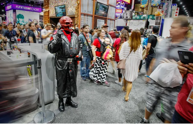 Mark Dye, dressed as the Red Skull, a villain from Captain America, holds a pose among the throng of people on Saturday during the Comic-Con International Convention in San Diego, California on July 22, 2017. (Photo by Eduardo Contreras/San Diego Union-Tribune via ZUMA Press/Rex Features/Shutterstock)