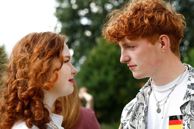 Bryan, 21, looks at a woman, 20, both from Germany, as they attend the annual Redhead Days Festival in Tilburg, Netherlands on August 27, 2023. (Photo by Piroschka van de Wouw/Reuters)