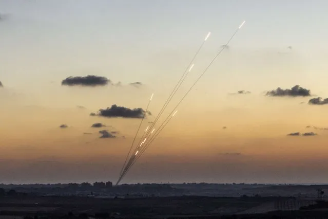 A picture taken from the southern Israeli city of Sderot shows rockets being fired from the Gaza strip into Israel, on July 13, 2014. Israel sharpened its campaign against Gaza Sunday, warning Palestinians in the north to flee after marines mounted a ground attack, as diplomatic efforts to halt the bloodshed intensified. (Photo by Jack Guez/AFP Photo)