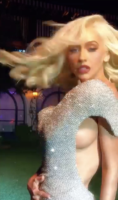 Grabs from footage posted on Instagram by Christina Aguilera in which she accidentally flashed her breast on October 16, 2024. The singer posted a clip of her wearing a silver dress and looking like Marilyn Monroe while dancing to Raye when she exposed her side-boob. (Photo by Ruckas Videograbs)