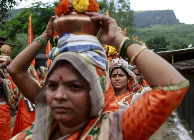 Devotees carry metal pitchers as they participate in a parade during “Kumbh Mela” or the Pitcher Festival in Trimbakeshwar, India, August 18, 2015. (Photo by Danish Siddiqui/Reuters)