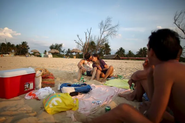 Indira Estrada, 26, who works in informatics, kisses her boyfriend, engineer Raiko Bonet, 27, at Megano beach in Havana, May 22, 2015. (Photo by Alexandre Meneghini/Reuters)