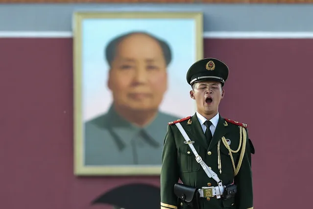 This photo taken on July 13, 2016 shows a paramilitary policeman standing guard in Beijing's Tiananmen Square, near the portrait of late communist leader Mao Zedong. The Philippines urged Beijing on July 14 to respect an international tribunal's ruling that rejected Chinese claims to most of the South China Sea, and said it would raise the issue at a regional summit. (Photo by AFP Photo/Stringer)