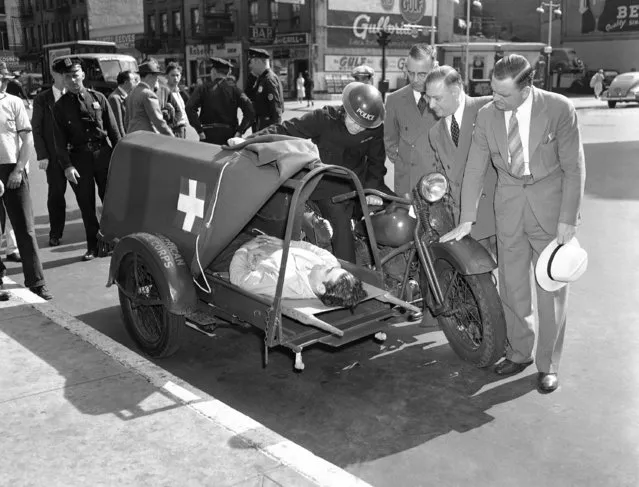 Developed for the British American Ambulance Corps, this new motorcycle ambulance is capable of speeding wounded soldiers 90 miles an hour from the front lines to field hospitals. Its springs are synchronized with the patient?s heartbeat to avoid increasing fever when traveling over various Terrain. Viewing it in New York  August 27, 1941, are left to right: constable Herbert Scott of England, driver; William E. Detlor, whose firm developed the vehicle; M. W. Stand, inspector-general of Civilian Defense, and Maj. Edward Riekert, also. (Photo by AP Photo)