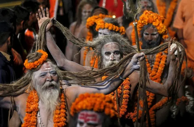 Naga Sadhus, or Hindu holy men, arrive to take a dip in a holy pond during the first Shahi Snan (grand bath) at Kumbh Mela, or Pitcher Festival, in Trimbakeshwar, India, August 29, 2015. (Photo by Shailesh Andrade/Reuters)