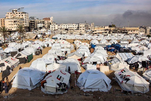 This view shows a camp of tents sheltering Palestinians displaced from north of Gaza City in an empty plot of government-owned land in the city-centre on December 11, 2024 amid the ongoing war in the Palestinian territory between Israel and Hamas. (Photo by Omar Al-Qattaa/AFP Photo)