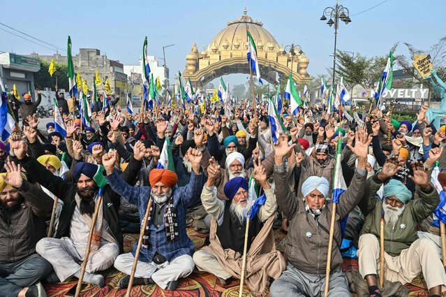 Farmers shout slogans as they block a road during the “Punjab Bandh”, a statewide strike by farmers against the central government demanding minimum support price (MSP) for their crops, on the outskirts of Amritsar on December 30, 2024. (Photo by Narinder Nanu/AFP Photo)