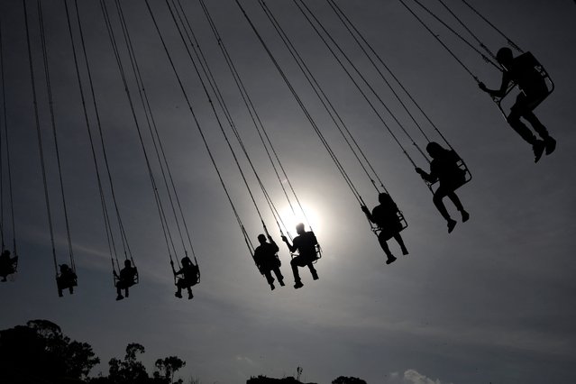 People ride on a Boxing Day Merry-go-round ride in Nairobi, Kenya, on December 26, 2024. (Photo by Simon Maina/AFP Photo)