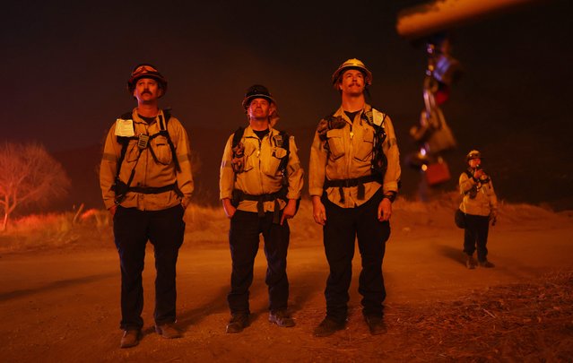 Firefighters keep watch as the Hughes Fire burns north of Los Angeles on January 22, 2025 near Castaic, California. The fire is prompting mandatory evacuations little more than two weeks after the Eaton and Palisades Fires and has grown to 9,400 acres. (Photo by Mario Tama/Getty Images/AFP Photo)