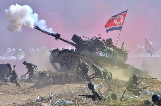 South Korean soldiers play the roles of both South Korean forces and invading North Korean soldiers during a re-enactment of the 1950 battle of Nakdong River to mark the 65th anniversary at the town of Waegwan in Chilgok county on September 10, 2015. The Korean peninsula is the world's last Cold War frontier as Stalinst North Korea and pro-Western South Korea have been technically at war since the 1950-53 Korean War. (Photo by Jung Yeon-Je/AFP Photo)