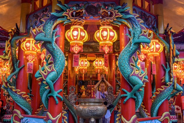 A man offers prayers at the Amurva Bhumi Vihara temple on the eve of the Lunar New Year of the Snake in Jakarta on January 28, 2025. (Photo by Bay Ismoyo/AFP Photo)