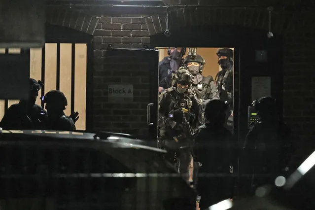 Armed police officers work at a block of flats off Basingstoke Road in Reading after an incident at Forbury Gardens park in the town centre of Reading, England, early Sunday, June 21, 2020. Several people were injured in a stabbing attack in the park on Saturday, and British media said police were treating it as “terrorism-related”. (Photo by Steve Parsons/PA Wire via AP Photo)