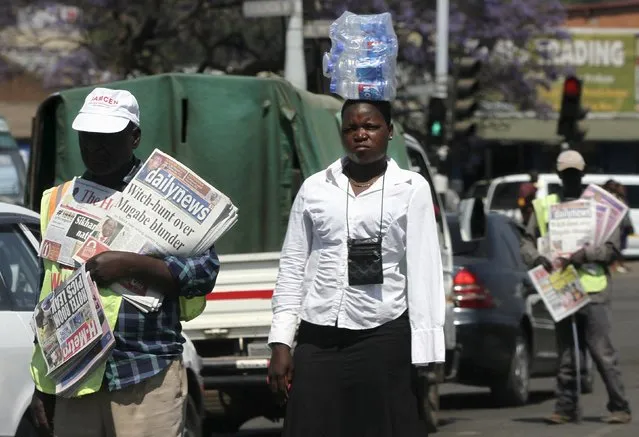 Hawkers sell goods on the streets of Zimbabwe's capital Harare, September 17, 2015. Most Zimbabweans survive through vending and hawking and even the country's police are no exception. As Zimbabwe sheds any veneer of formally regulated commerce, a host of vendor unions claim to represent between 100,000 and 6 million traders, nearly half the nation's 13 million people. (Photo by Philimon Bulawayo/Reuters)