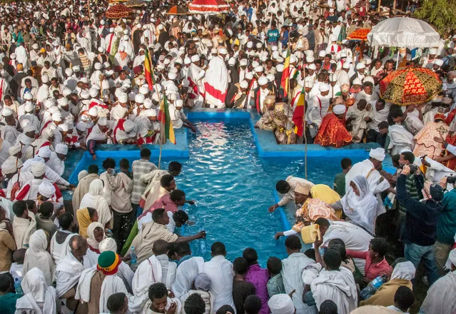 On the following morning, crowds gather round a cross-shaped baptismal pool that represents the River Jordan, where Jesus was baptised by John the Baptist. (Photo by Ethiopia – The Living Churches of an Ancient Kingdom/The American University in Cairo Press/The Guardian)