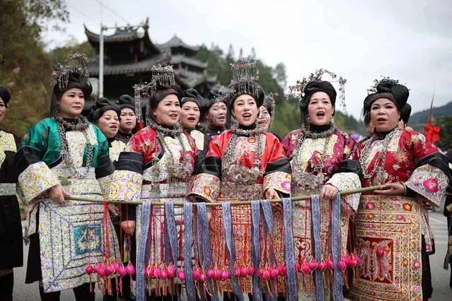 This photo taken on November 24, 2022 shows women of the Dong ethnic minority singing songs during celebration of the Dongnian festival in Rongjiang county, Qiandongnan Miao and Dong Autonomous Prefecture, in China's southwestern Guizhou province. (Photo by Reuters/China Stringer Network)