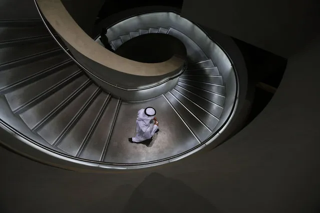An Emirati man walks down stairs in Masdar City, on the outskirts of the rich Emirate of Abu Dhabi, on October 7, 2015. Masdar City is a high-density, pedestrian-friendly development where current and future renewable energy and clean technologies are showcased, marketed, researched, developed, tested and implemented. (Photo by Karim Sahib/AFP Photo)
