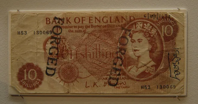 A forged British 10 shilling note from the late 1950's is displayed as part of the Crime Museum Uncovered exhibition at the Museum of London in the City of London, Wednesday, October 7, 2015. (Photo by Alastair Grant/AP Photo)