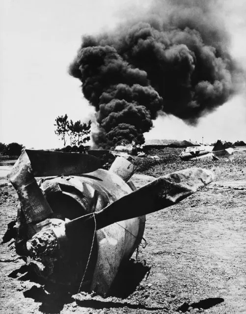 Broken and burning fiercely, P-47 fighter crashed during takeoff in the Ryukyus on July 21, 1945 for a strike against the Japanese homeland. The engine in the foreground was thrown far away from the main wreckage in background. The pilot escaped with minor injuries. (Photo by AP Photo)