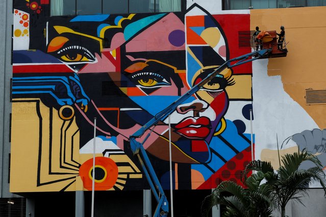 Street artists who came to participate in the first edition of Graff Ivoire, paint a mural on the facade of the Pullman hotel, in Abidjan, Ivory Coast on November 17, 2024. (Photo by Luc Gnago/Reuters)