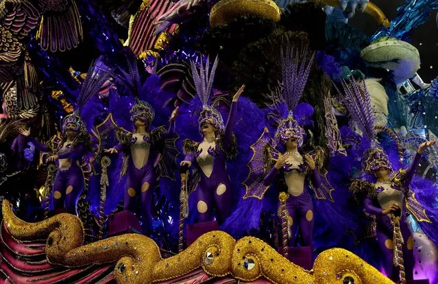 Dancers  from the Nene da Vila Matilde samba school perform on a float during a carnival parade in Sao Paulo, Brazil, Saturday, February 9, 2013. (Photo by Andre Penner/AP Photo)