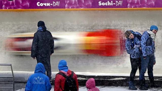 Spectators watch competitions during the 4-men's bob event at the FIBT Bob & Skeleton World Cup 2013, in Krasnaya Polyana, Russia, on February 17, 2013. (Photo by Mikhail Metzel/Associated Press)