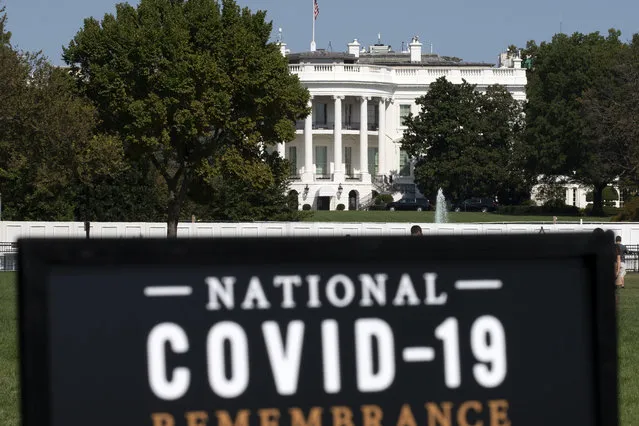 The White House is seen in the background as sign of the National COVID-19 Remembrance, event at The Ellipse outside of the White House, Sunday, October 4, 2020, in Washington. More Americans blame the U.S. government than foreign powers for the coronavirus crisis in United States, rejecting the Trump administration’s contention that China is most at fault for the spread of the disease. That's according to a new poll by The University of Chicago Harris School of Public Policy and The Associated Press-NORC Center for Public Affairs Research. (Photo by Jose Luis Magana/AP Photo)