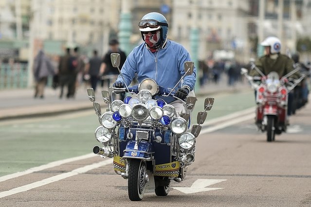 A rider makes his way down Madeira Drive on his scooter on April 14, 2024 in Brighton, England. In May 1964, more than 1000 members of rival gangs of youths known as the Mods and Rockers clashed in the South Coast seaside resort of Brighton on Bank Holiday weekend. They fought each other on Brighton beach, in scenes which were later immortalised in the cult film, Quadrophenia. (Photo by Alan Crowhurst/Getty Images)