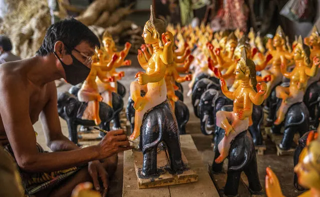 An artist puts the final touches to an idol of Vishwakarma, the four-hands Hindu God of Architecture, sitting on an elephant, ahead of the Vishwakarma Puja of the Bengali Hindu community in Dhaka, Bangladesh, 08 September 2020. The Vishwakarma Puja festival falls on the last day of the Bangla month of Bhadra which is also known as Bhadra Sankranti. (Photo by Monirul Alam/EPA/EFE/Rex Features/Shutterstock)