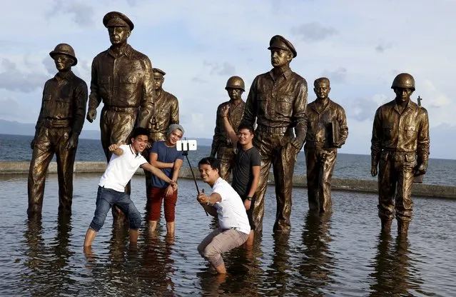 Local tourists take a "selfie" in front of the bronze images of U.S. General Douglas McArthur and his officers at a memorial in Palo, Leyte in central Philippines November 2, 2015, ahead of the second anniversary of a devastating typhoon that killed more than 6,000 people in central Philippines. (Photo by Erik De Castro/Reuters)