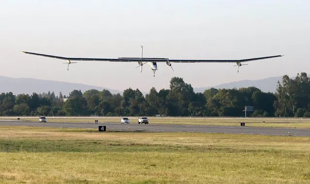 The Solar Impulse lands during a test flight at Moffett Field NASA Ames Research Center in Mountain View, Calif., Friday, April 19, 2013. A solar-powered plane that has wowed aviation fans in Europe is set to take an early morning test flight over the San Francisco Bay area. Considered the world's most advanced sun-powered plane, the Solar Impulse is set to take off from Moffett Field in Mountain View at first light for a two-hour practice run leading up to the start of a multi-city, cross-country tour. (Photo by Jeff Chiu/AP Photo)