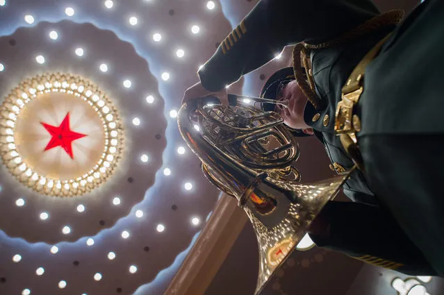 A member of a military band plays the national anthem during the closing session of the National People' s Congress at the Great Hall of the People in Beijing on March 20, 2018. (Photo by Nicolas Asfouri/AFP Photo)