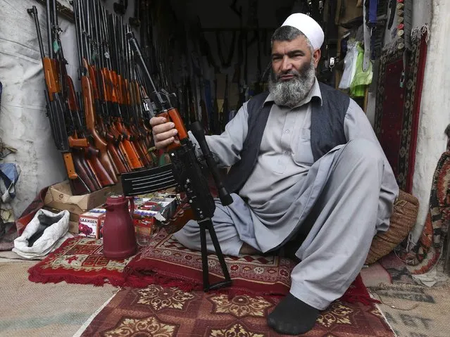 A man sells weapons on a street in the Afghan capital,  Kabul on April 22, 2013. (Photo by Omar Sobhani/Reuters)