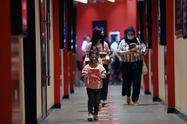 People arrive to watch a film after movie theaters reopened within the easing coronavirus (Covid-19) pandemic restrictions in Baghdad, Iraq on October 15, 2020. (Photo by Murtadha Al-Sudani/Anadolu Agency via Getty Images)