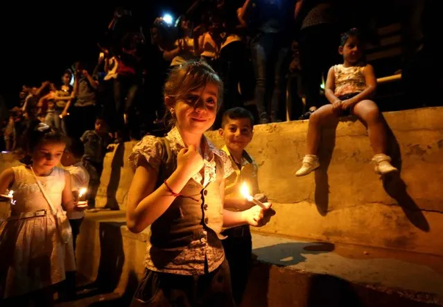 Displaced Iraqi Christians take part in celebrations on October 18, 2016 in Arbil, the capital of the autonomous Kurdish region of northern Iraq, to mark the liberation of Qaraqosh, that was Iraq' s largest Christian town before it was overrun by the Islamic State (IS) jihadi group in August 2014 Tens of thousands of Iraqi forces were making gains from the Islamic State group in Mosul Tuesday in an offensive US President Barack Obama warned would be a “difficult fight”. (Photo by Safin Hamed/AFP Photo)