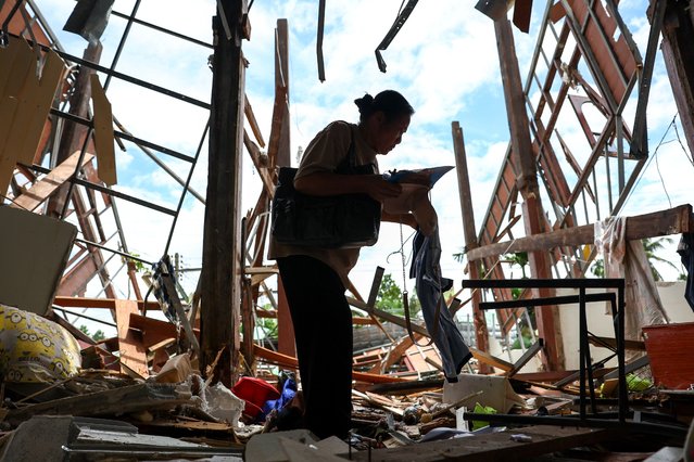 Koon Kantho, 68, collects items from her house destroyed during Cambodia's artillery attacks, in Sisaket province, Thailand, on July 29, 2025. (Photo by Athit Perawongmetha/Reuters)