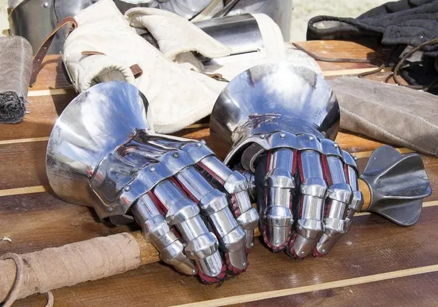 Metal gloves lay on a table during the “Battle of Nations” in Aigues-Mortes, southern France, Friday, May 10, 2013 where Middle Ages fans attend the historical medieval battle  competition. The championship will be attended by 22 national teams, which is twice the number it was last year. The battle lasts until May 12. (Photo by Philippe Farjon/AP Photo)