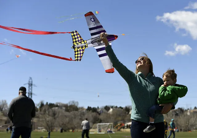 Courtney Dinnel and her son Calvin, 1, try to get their kite into the air during  the annual Arvada Kite Festival at Stegner Sports Complex on April 8, 2018 in Arvada, Colorado. The wind, while gusty at times, was perfect for flying kites and hundreds of people turned out for the free event. The event also included live music, community and food booths and free kids activities. (Photo by Helen H. Richardson/The Denver Post)