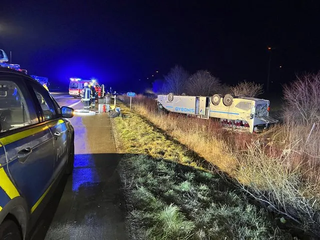 A bus belonging to a tour company from Poland is lying on its roof after an accident on the A2 near Bornstedt, Germany, Friday, February 10, 2023. (Photo by Thomas Schulz/dpa via AP Photo)