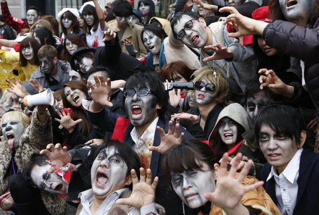 People, dressed as zombies, pose for photos after the Roppongi Zombie Walk in Tokyo March 31, 2013. (Photo by Yuya Shino/Reuters)
