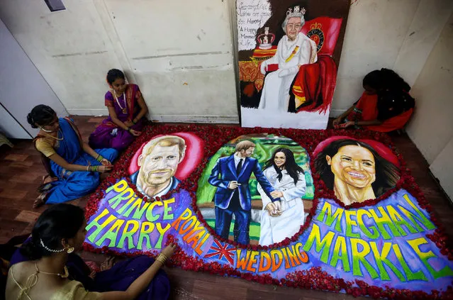 Students of an art school give finishing touches to a painting created to commemorate the royal wedding of Britain's Prince Harry and his fiancee Meghan Markle, in Mumbai, India May 18, 2018. (Photo by Francis Mascarenhas/Reuters)