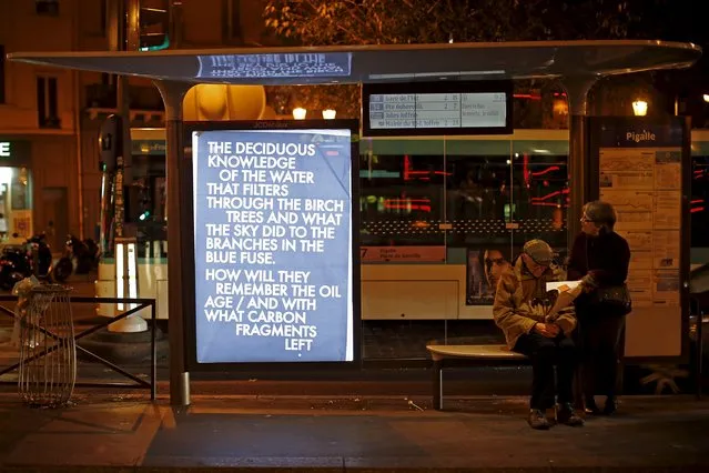 A poster by street artist Robert Montgomery as part of the "Brandalism" project is displayed at a bus stop in Paris, France, November 28, 2015, ahead of the United Nations COP21 Climate Change conference in Paris. (Photo by Benoit Tessier/Reuters)