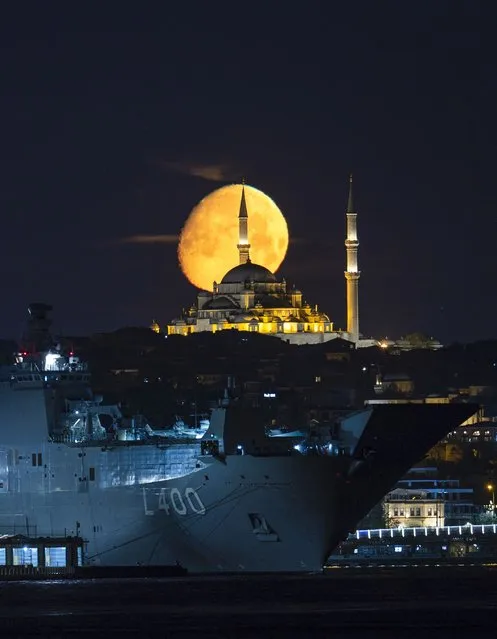 Moon appears over TCG Anadolu, Turkiye's largest warship and the world's first unmanned combat aerial vehicle (UCAV) carrier and Fatih Mosque in Istanbul, Turkiye on May 02, 2023. (Photo by Isa Terli/Anadolu Agency via Getty Images)