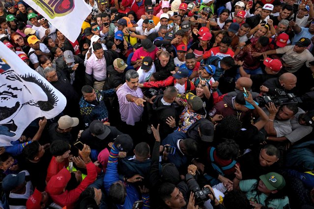 Venezuela's President Nicolas Maduro gestures among people during a demonstration on Youth Day in Caracas on November 13, 2025. (Photo by Juan Barreto/AFP Photo)