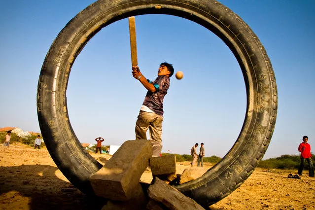 “Village Boys play cricket in Gujurat, India”. Cricket is the passion and preferred pastime of almost every Indian boy. Just outside their small community in Eastern Gujurat, locals don't let scarcity of resources dull their fervour – improvising with an old tire for wickets and plank of wood for a bat. (Photo and caption by Danny Pemberton/National Geographic Traveler Photo Contest)