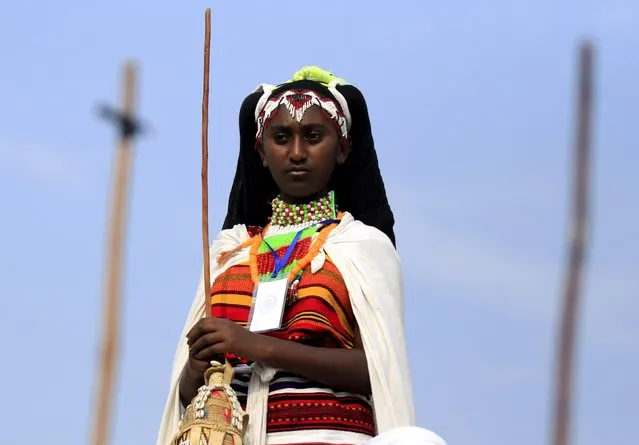 A cultural dancer from Oromiya region waits to perform at Gambela stadium during Ethiopia's Nations and Nationalities Festival in Gambela town, in Ethiopia, December 9, 2015. (Photo by Tiksa Negeri/Reuters)