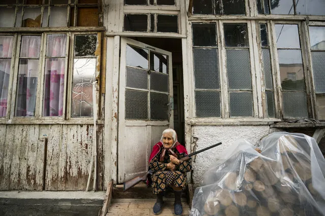 Old woman stands in the entrance of her home with a rifle during the shelling of the azeri army over Stepanakert city during the clashes between Azerbaijan and Nagorno Karabakh on October 4, 2020. The old woman is determined not to move and defend her home until the last moments. (Photo by Arce Lavin/ZUMA Wire/Rex Features/Shutterstock)
