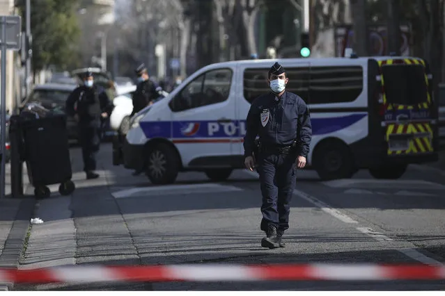 Police officers cordon off the area after a man visibly brandished a knife outside a Jewish school and a kosher market in Marseille, southern France, Friday, March 5, 2021. Police detained a man Friday who was wielding a knife outside a Jewish school and kosher market, and increased surveillance of Jewish sites in the city while they investigate his motives, according to local authorities. (Photo by Daniel Cole/AP Photo)