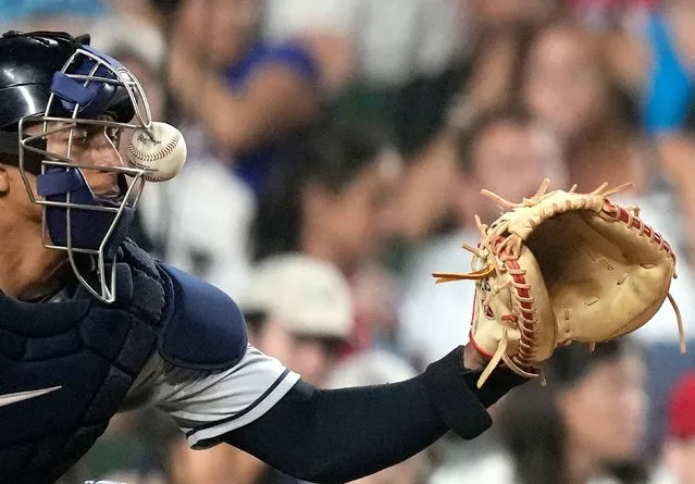 Cleveland Guardians catcher Bo Naylor is hit on the mask by a ball fouled off by Chicago Cubs' Seiya Suzuki during the fourth inning of a baseball game Saturday, July 1, 2023, in Chicago. (Photo by Charles Rex Arbogast/AP Photo)